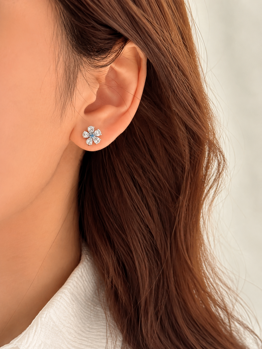 Lunelle Atelier Twin Bloom blue and white mismatched flower stud earrings displayed on a white background