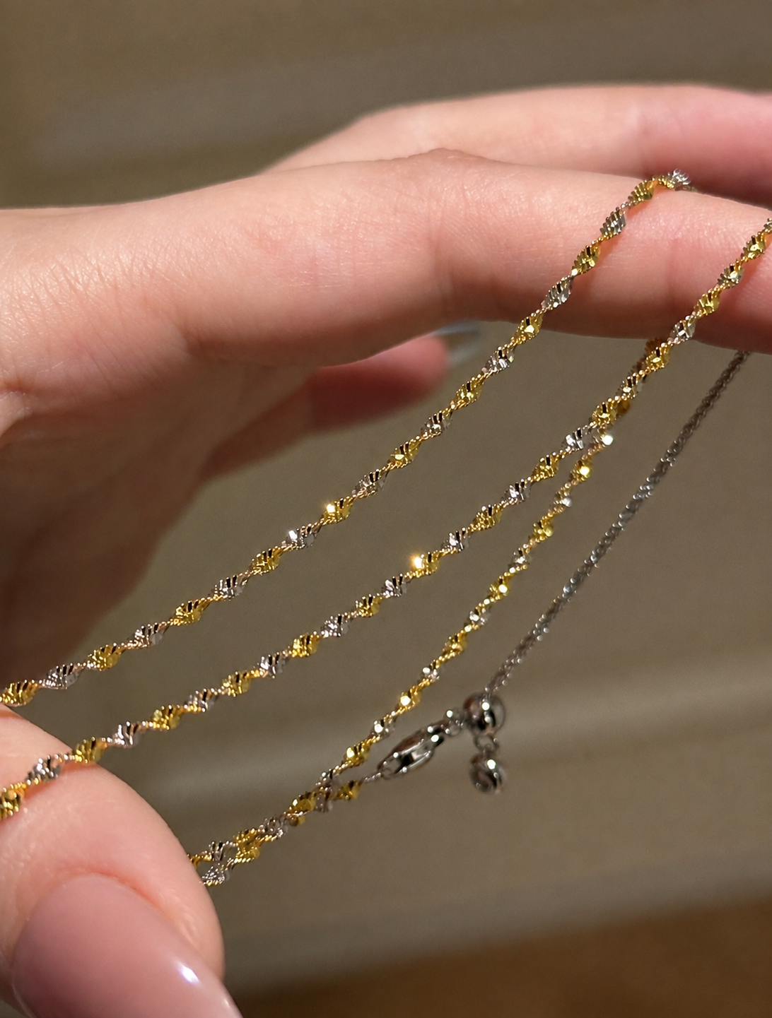 Two-tone shimmer wave chain necklace by Lunelle Atelier featuring a stylish, flowing design in mixed metallic finishes.