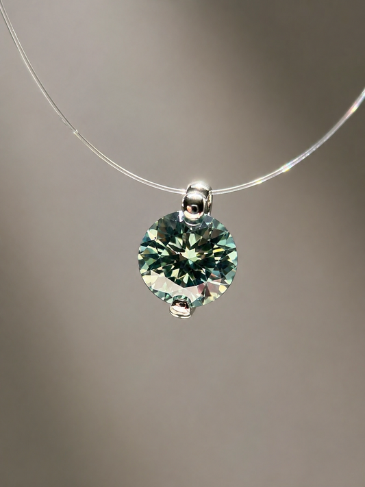 Necklace with a green gemstone pendant on a neutral background