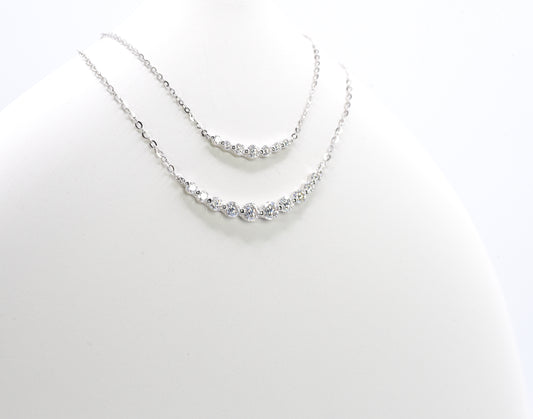 Silver necklaces with small Moissanite Stones on a white background