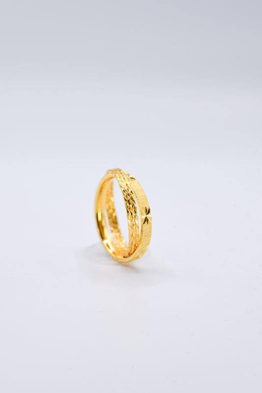 Gold ring on a light gray background
