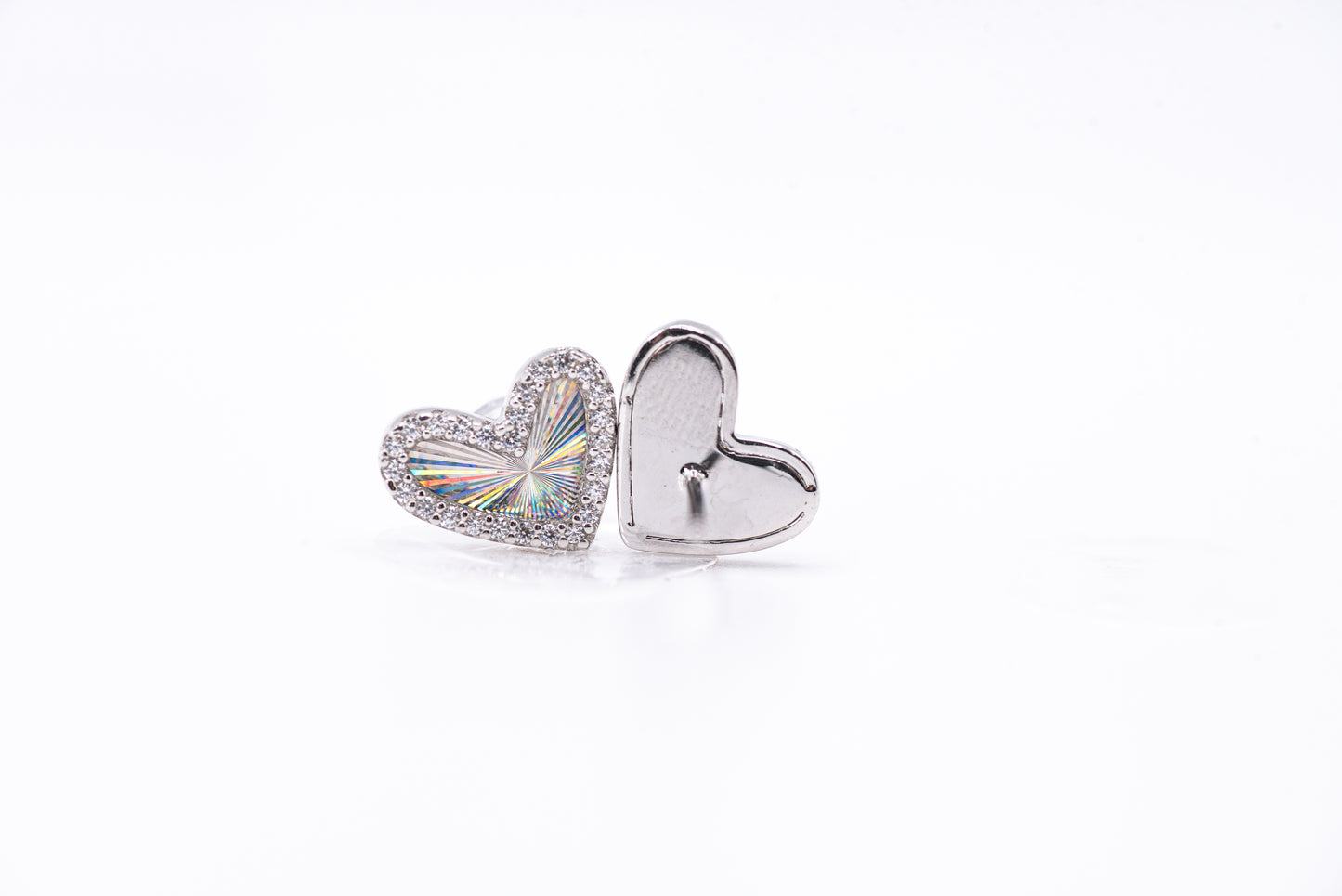 Heart-shaped silver earrings on a white background