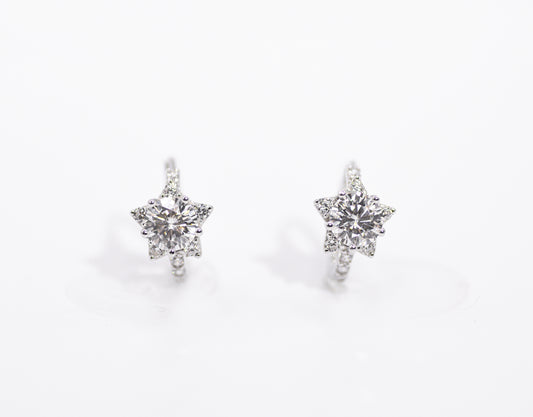 Star-shaped earrings with clear stones on a white background