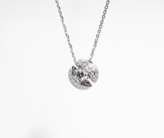 Silver necklace with a round pendant on a white background