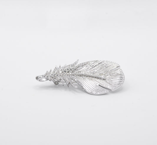 Silver feather-shaped pendant on a light gray background