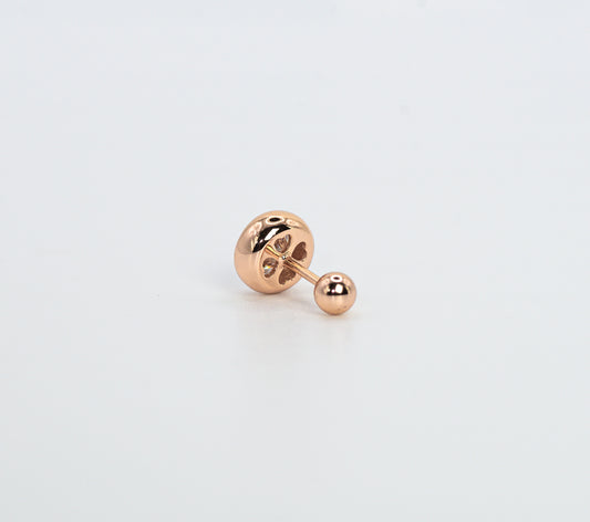 Rose gold color earring on a light gray background