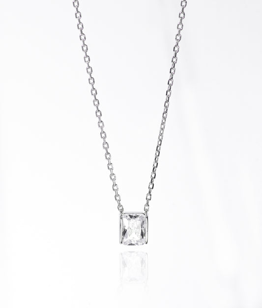Silver necklace with a square-cut pendant on a white background