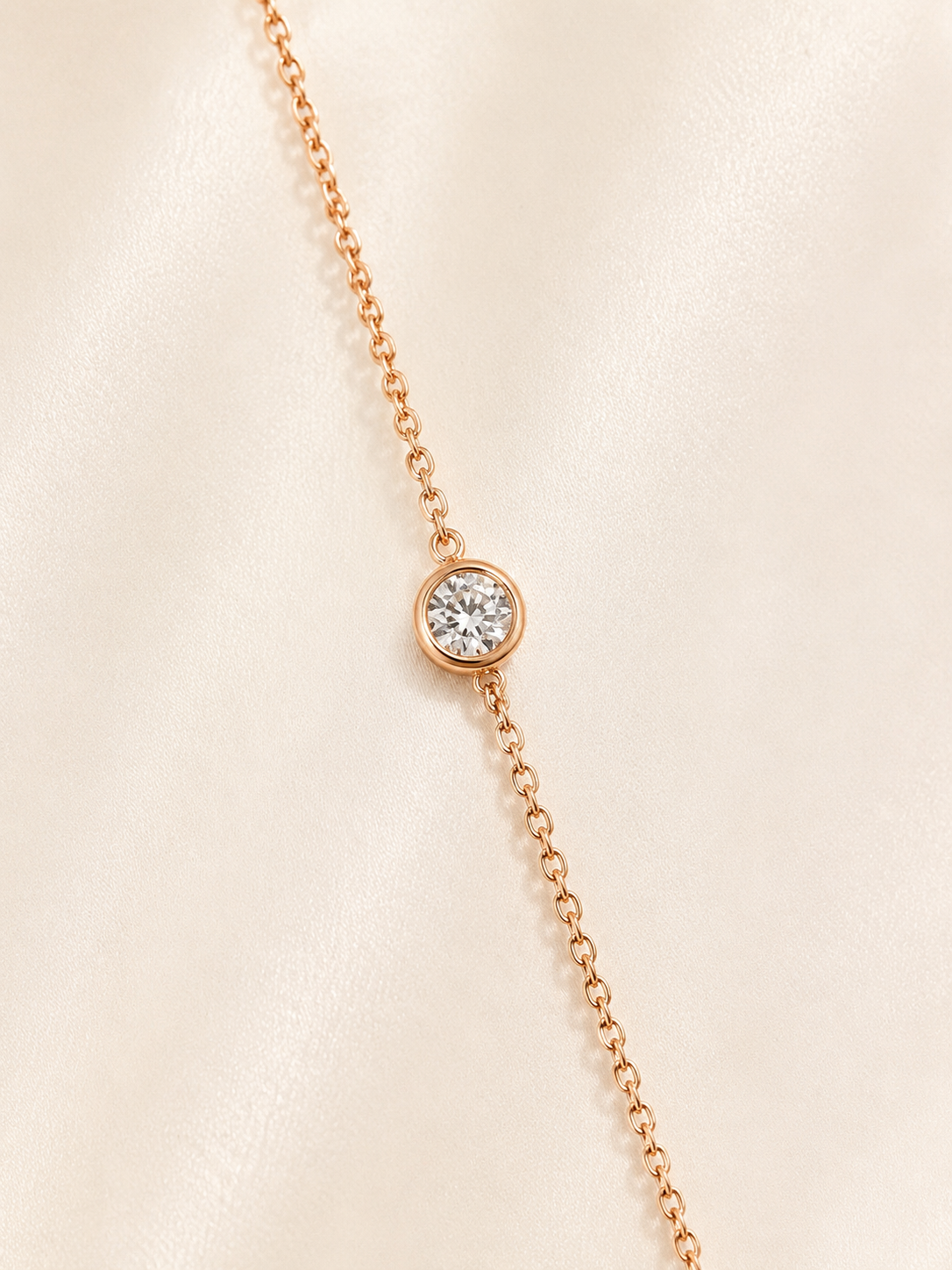 Lunelle Atelier single bubble moissanite bracelet with shimmering stones and delicate chain on a neutral background.