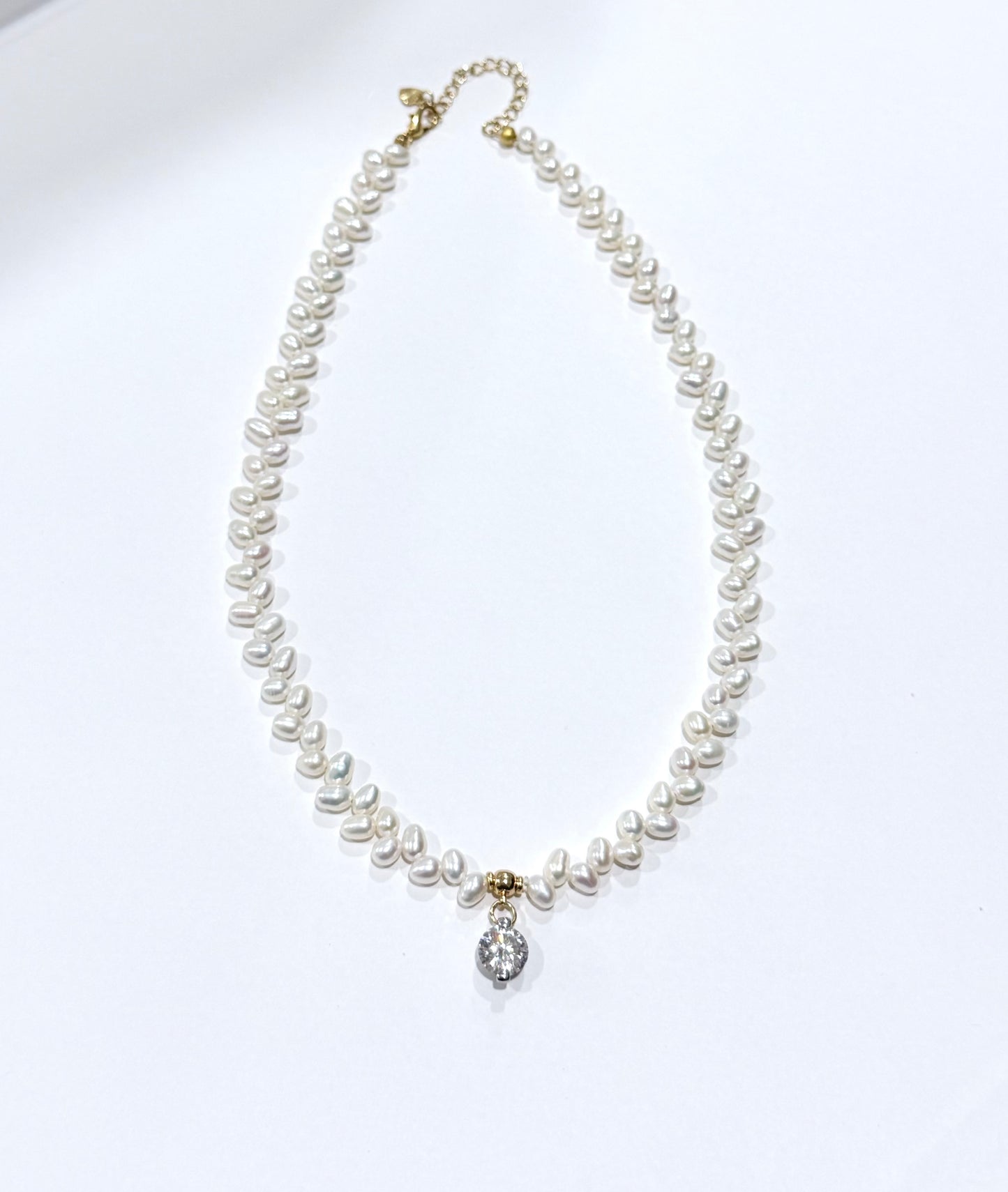 Pearl necklace with a silver clasp on a white background