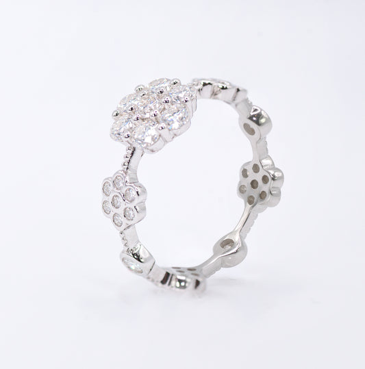 Silver ring with a floral design on a white background