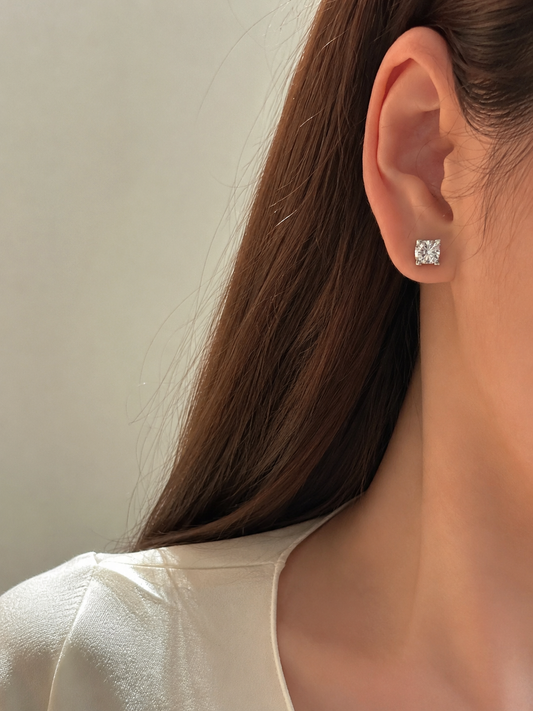 Lunelle Atelier sculpted solitaire lab-grown diamond stud earrings featuring a sleek, polished design on a white background.