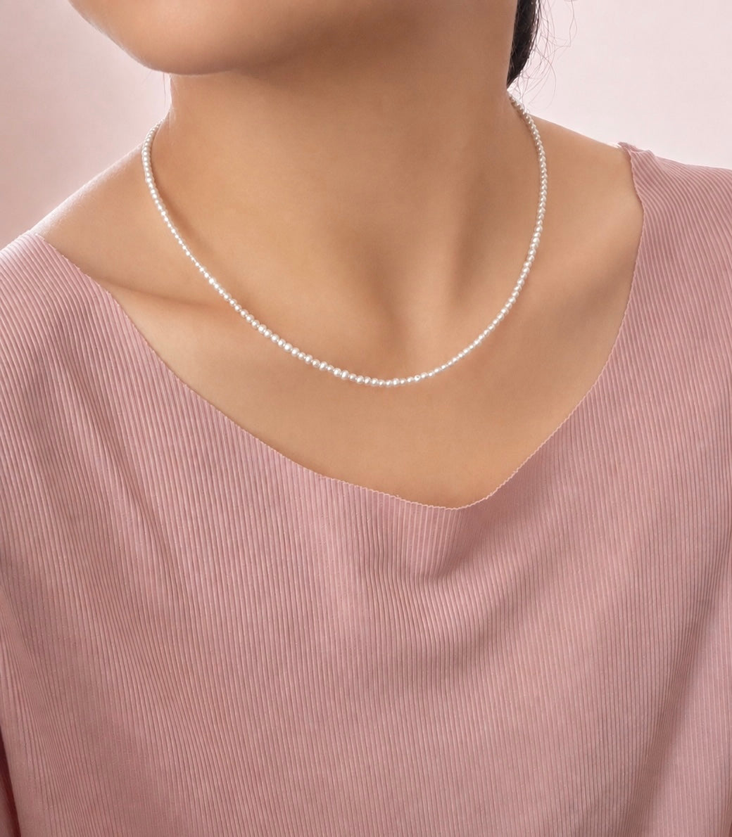 Lunelle by Heart and Hand Mini Freshwater Pearl Necklace with small white pearls on a delicate chain.