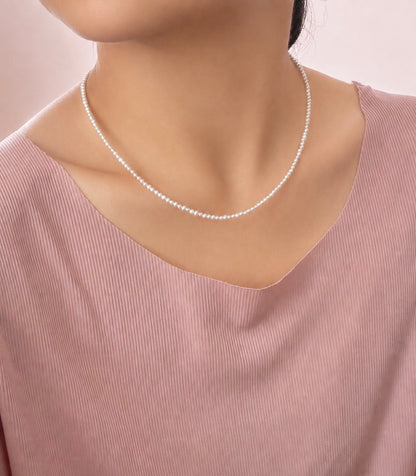 Lunelle by Heart and Hand Mini Freshwater Pearl Necklace with small white pearls on a delicate chain.