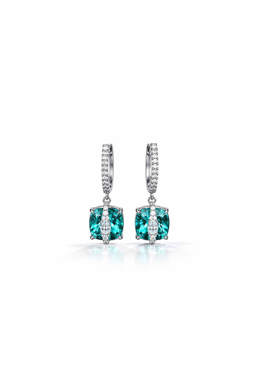 Pair of earrings with green gemstones on a white background