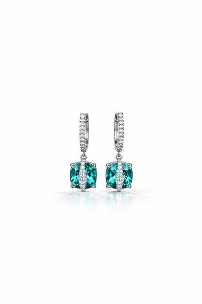 Pair of earrings with green gemstones on a white background