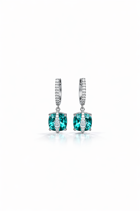 Pair of earrings with green gemstones on a white background