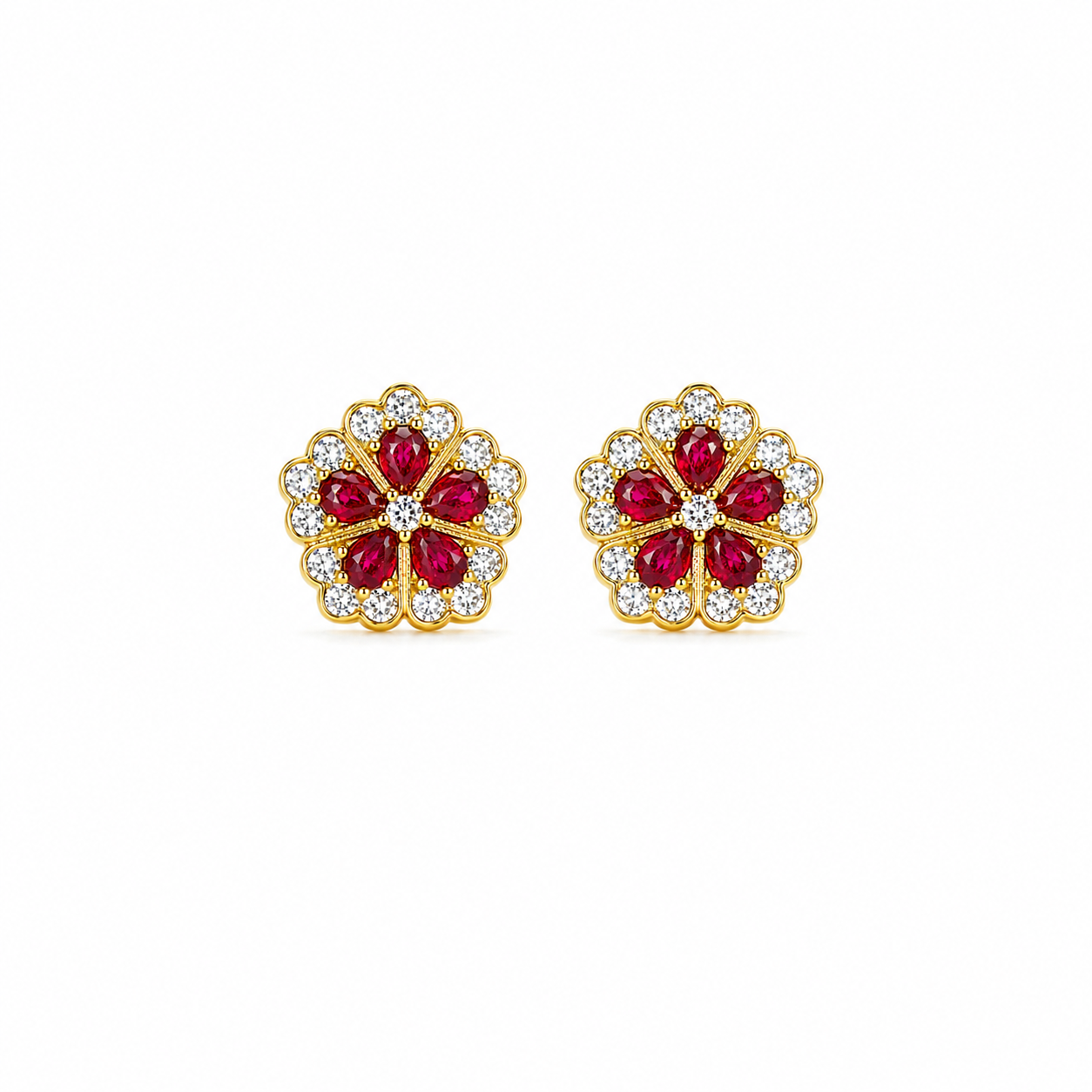 Gold earrings with red gemstones on a white background