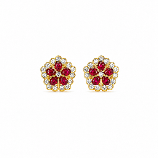 Gold earrings with red gemstones on a white background