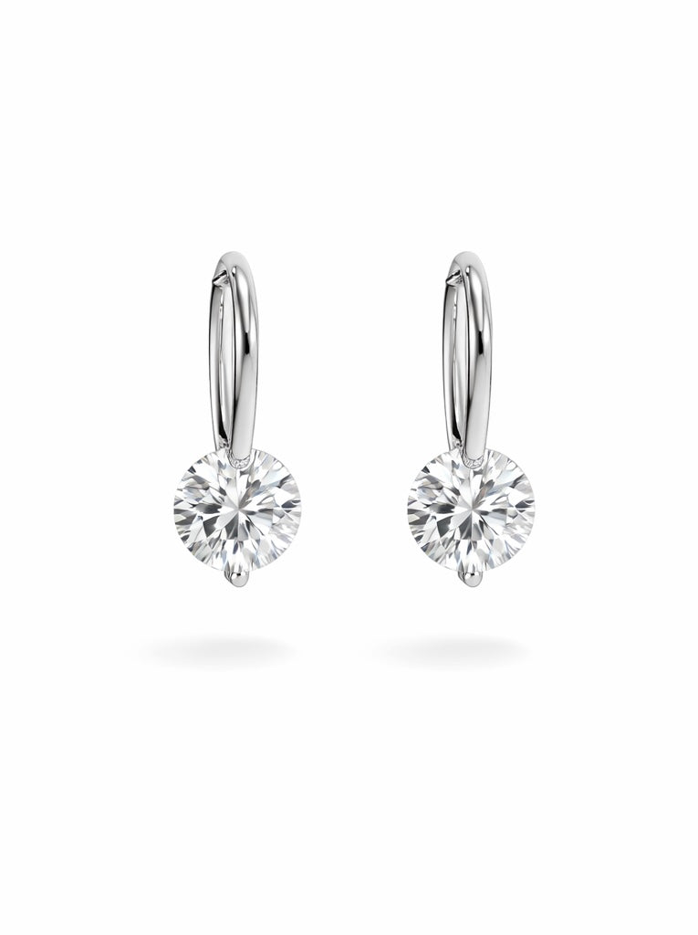 Pair of silver hoop earrings with clear gemstones on a white background