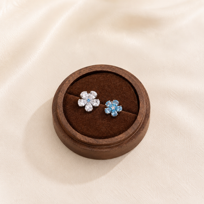 Lunelle Atelier Twin Bloom blue and white mismatched flower stud earrings featuring detailed floral designs.