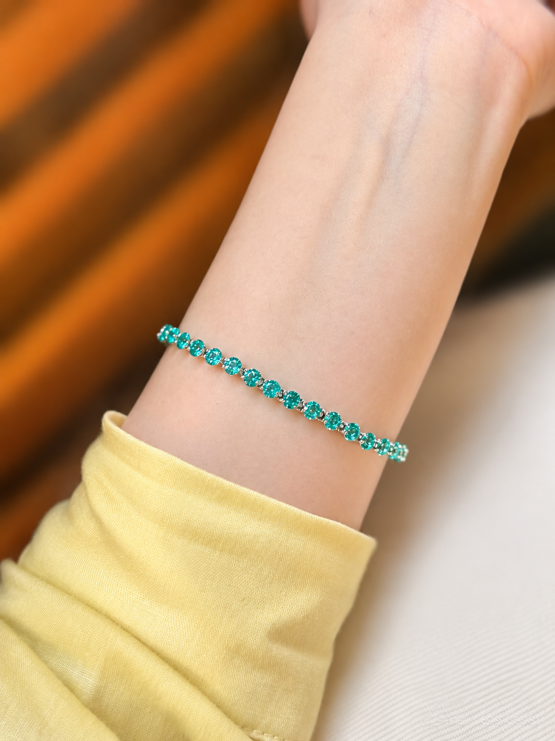 Lunelle Atelier floating round-cut tennis bracelet with sparkling gemstones, showcasing a delicate and elegant jewelry piece.