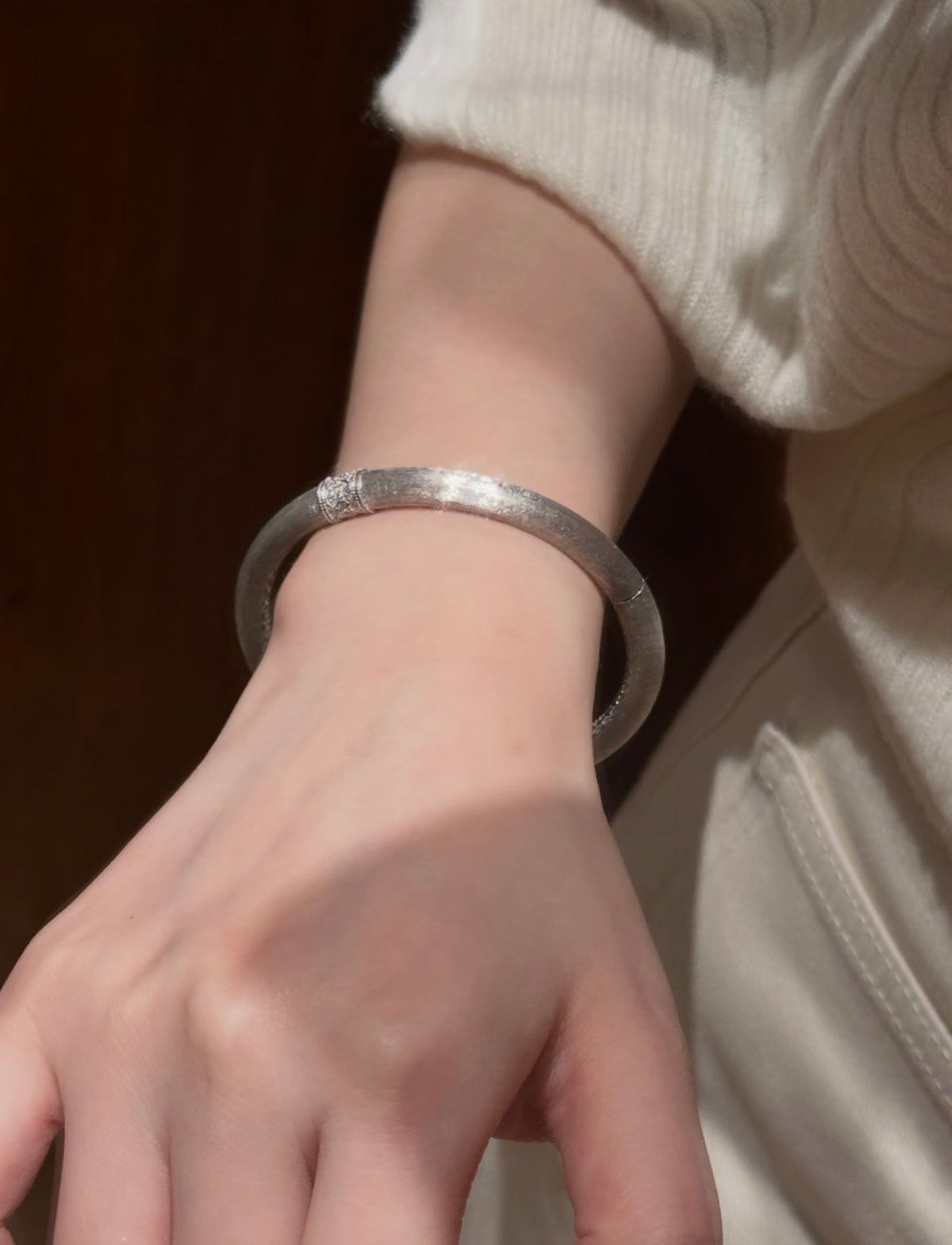 Hand-brushed rotating accent bangle bracelet by Lunelle Atelier featuring a sleek, modern design and rotating centerpiece.