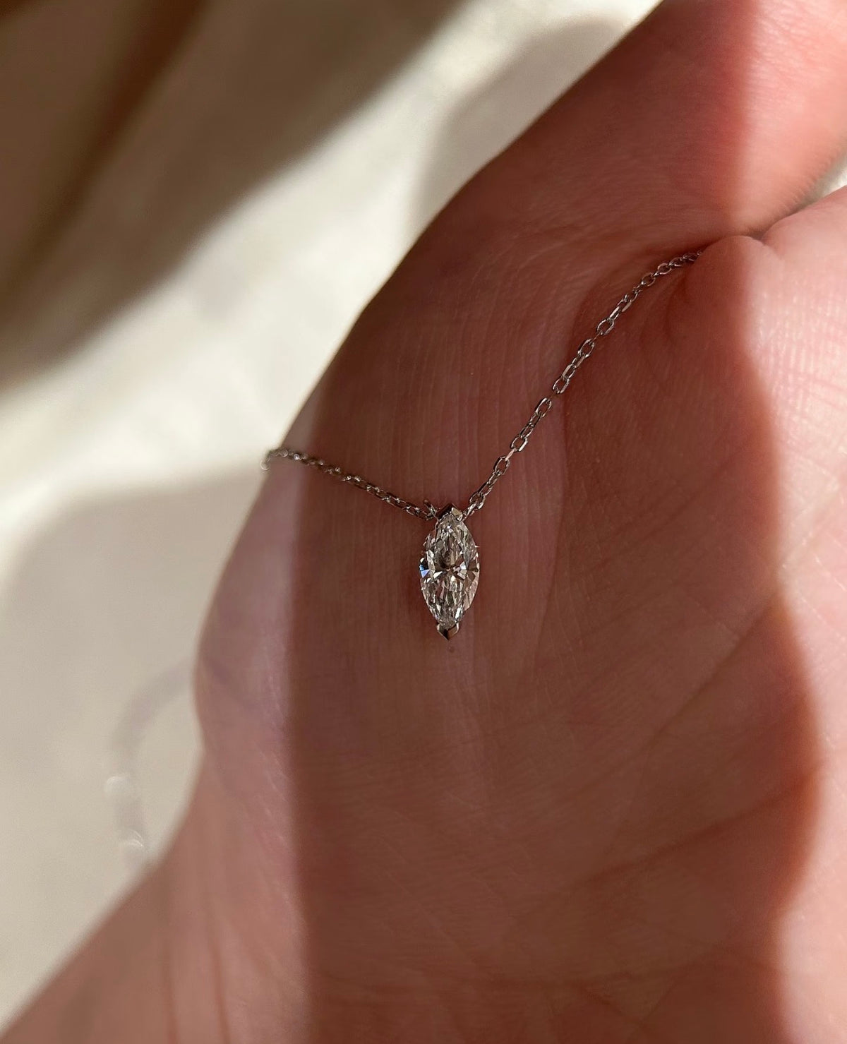 Lab-grown marquise diamond solitaire necklace by Lunelle Atelier featuring a delicate chain and sparkling gemstone pendant.