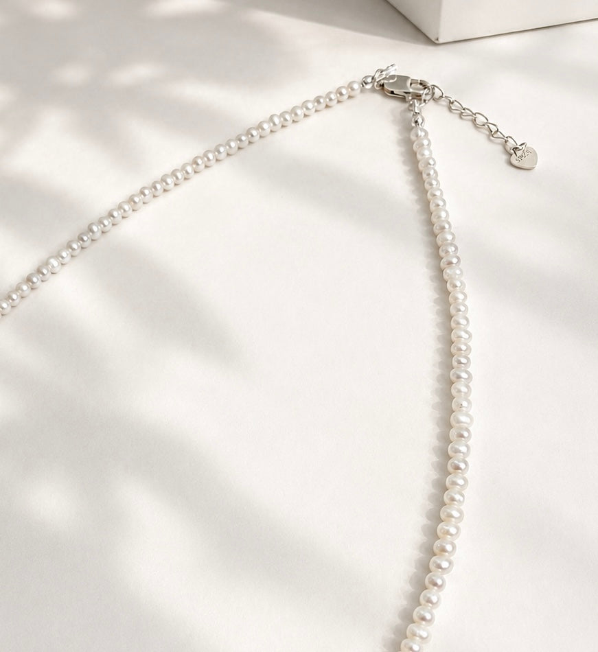 Lunelle by Heart and Hand Mini Freshwater Pearl Necklace with small white pearls on a delicate chain.