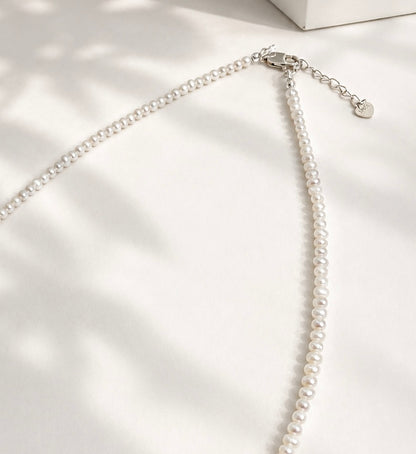 Lunelle by Heart and Hand Mini Freshwater Pearl Necklace with small white pearls on a delicate chain.