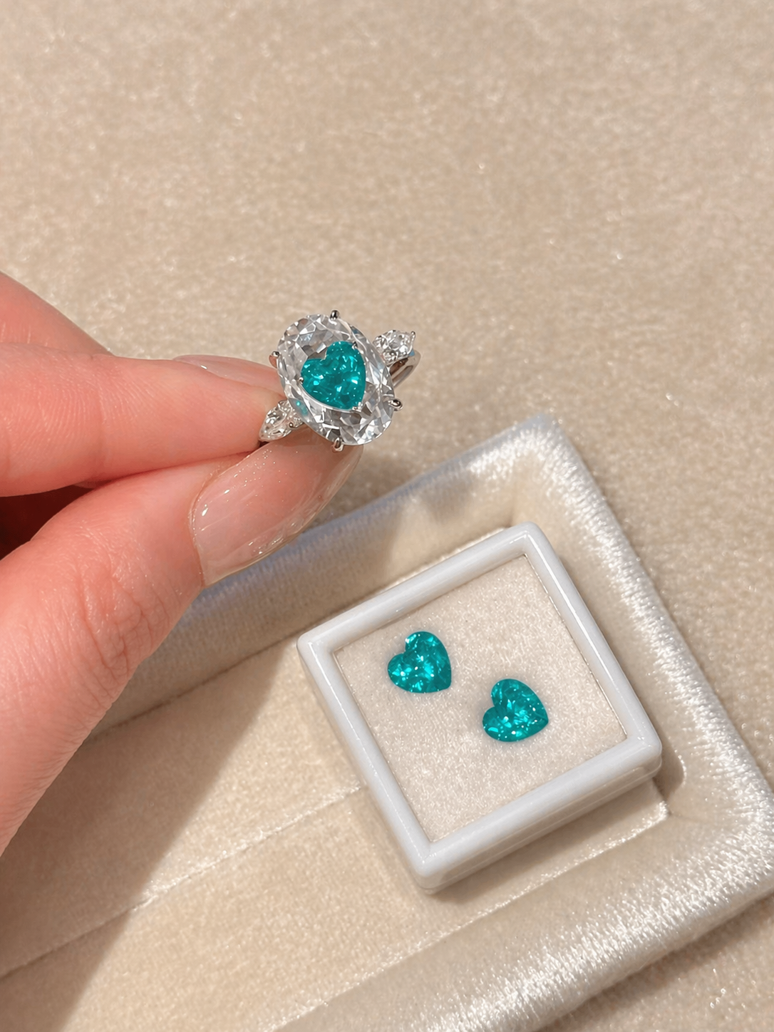 Turquoise heart-shaped jewelry on a beige surface