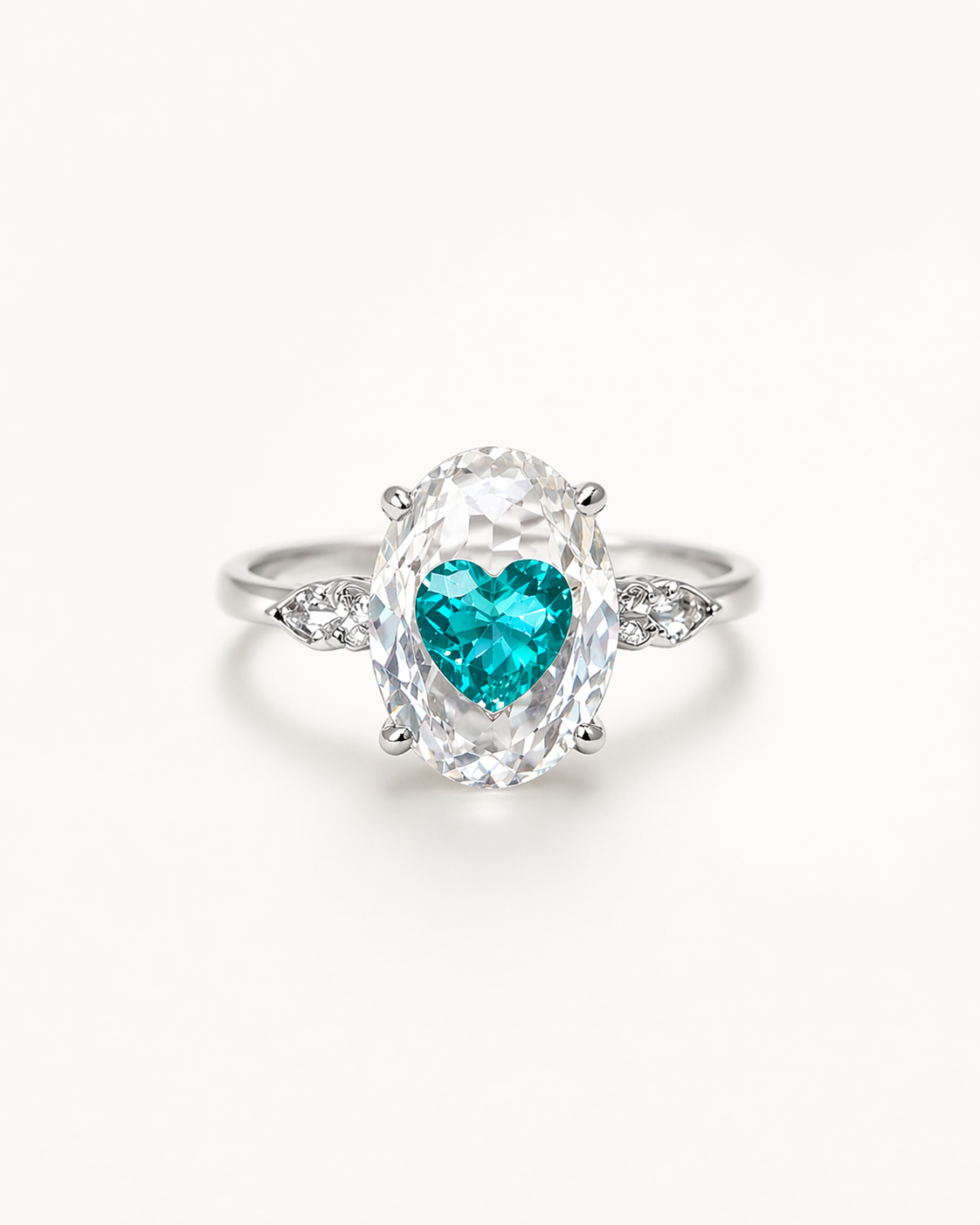 Ring with a heart-shaped green gemstone on a white background