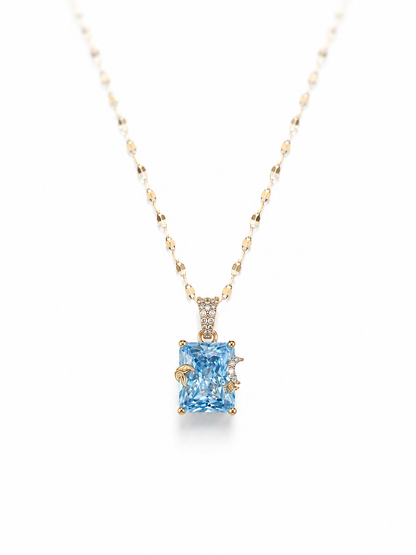 Rose gold necklace with a butterfly pendant featuring turquoise stones on a white background
