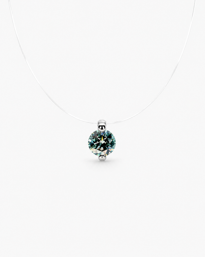 Silver pendant with a green gemstone on a white background