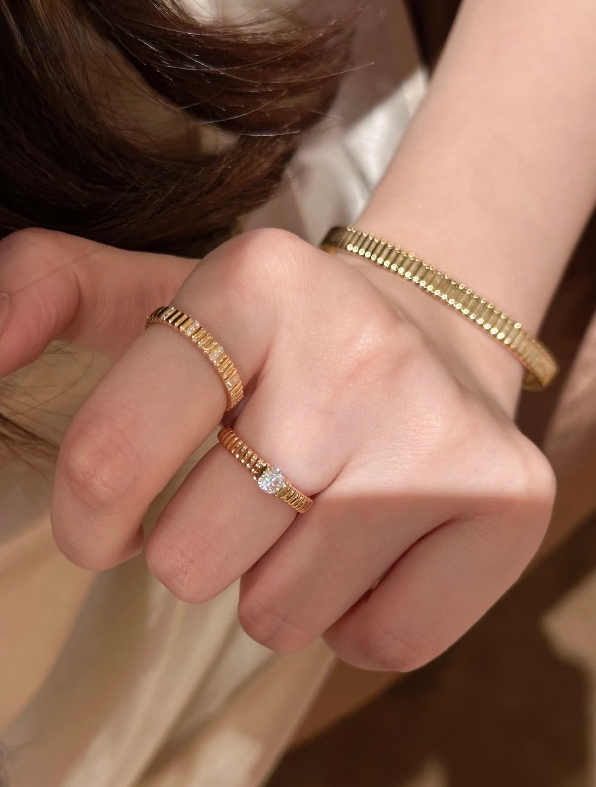 High-polish ribbed bangle bracelet from Lunelle Atelier, showcasing a sleek, shiny design with textured ribbed pattern.