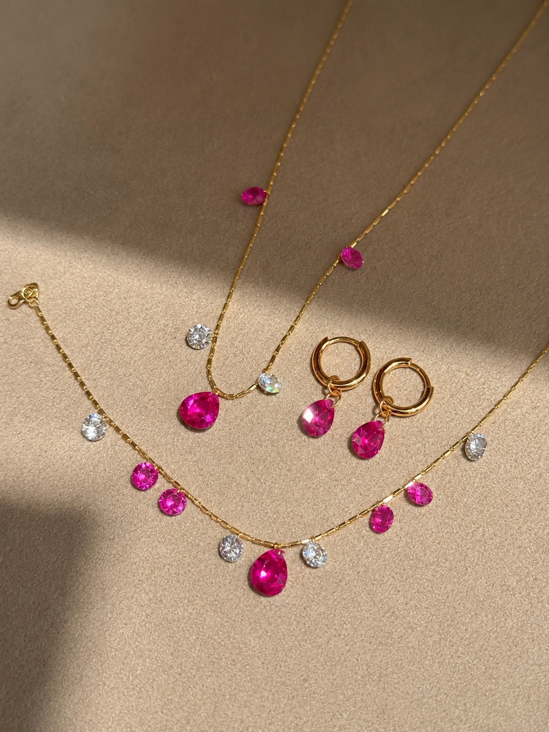 Convertible hot pink sapphire drop huggie earrings by Lunelle Atelier featuring vibrant pink sapphires and sleek gold hoops.