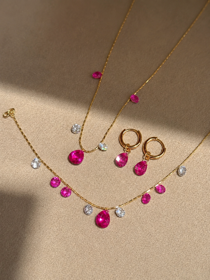 Convertible hot pink sapphire drop huggie earrings by Lunelle Atelier featuring vibrant pink sapphires and sleek gold hoops.