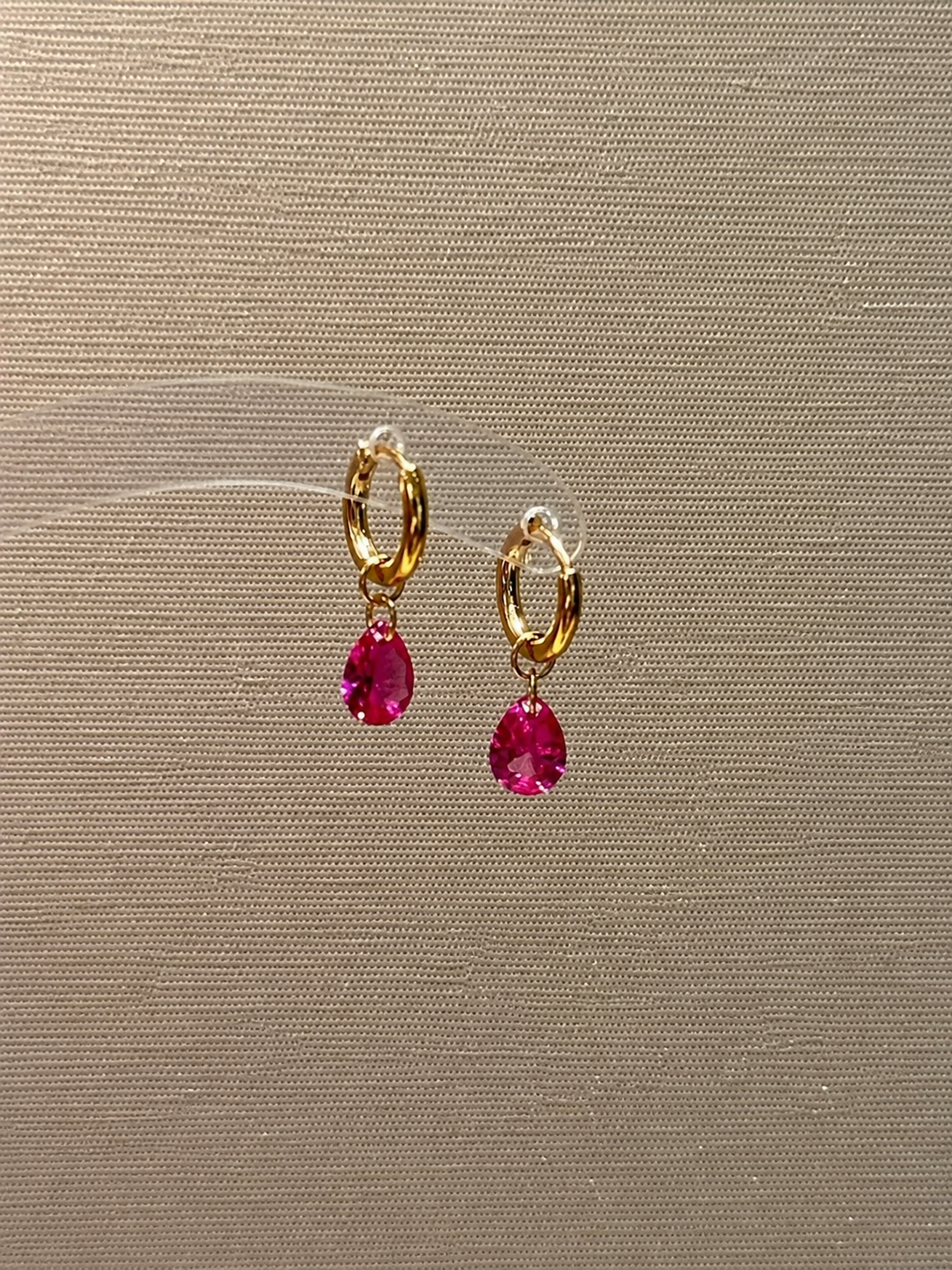 Hot pink sapphire drop huggie earrings by Lunelle Atelier, showcasing vibrant gemstones and sleek gold hoops.