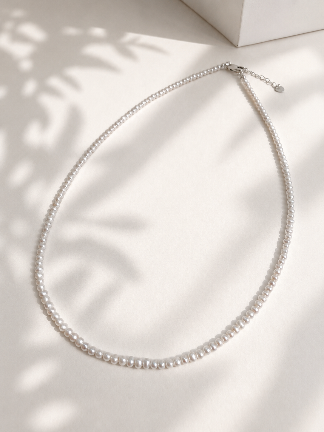 Lunelle by Heart and Hand mini freshwater pearl necklace featuring small, lustrous pearls on a delicate chain.