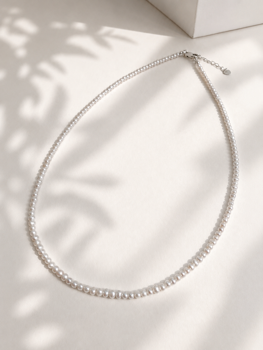 Lunelle by Heart and Hand mini freshwater pearl necklace featuring small, lustrous pearls on a delicate chain.