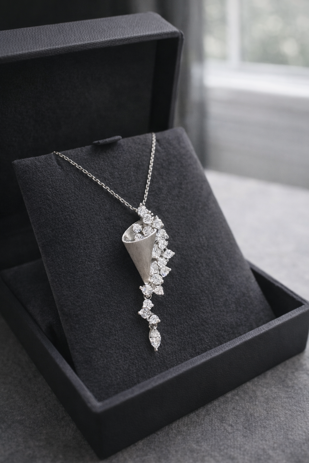 Silver necklace with a pendant in a black jewelry box