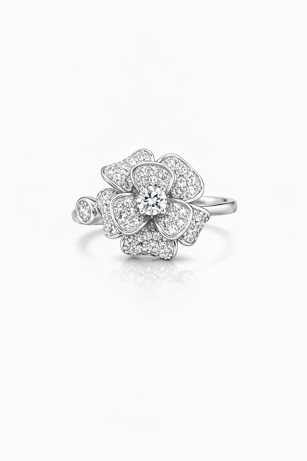 Silver flower-shaped ring with clear gemstones on a white background