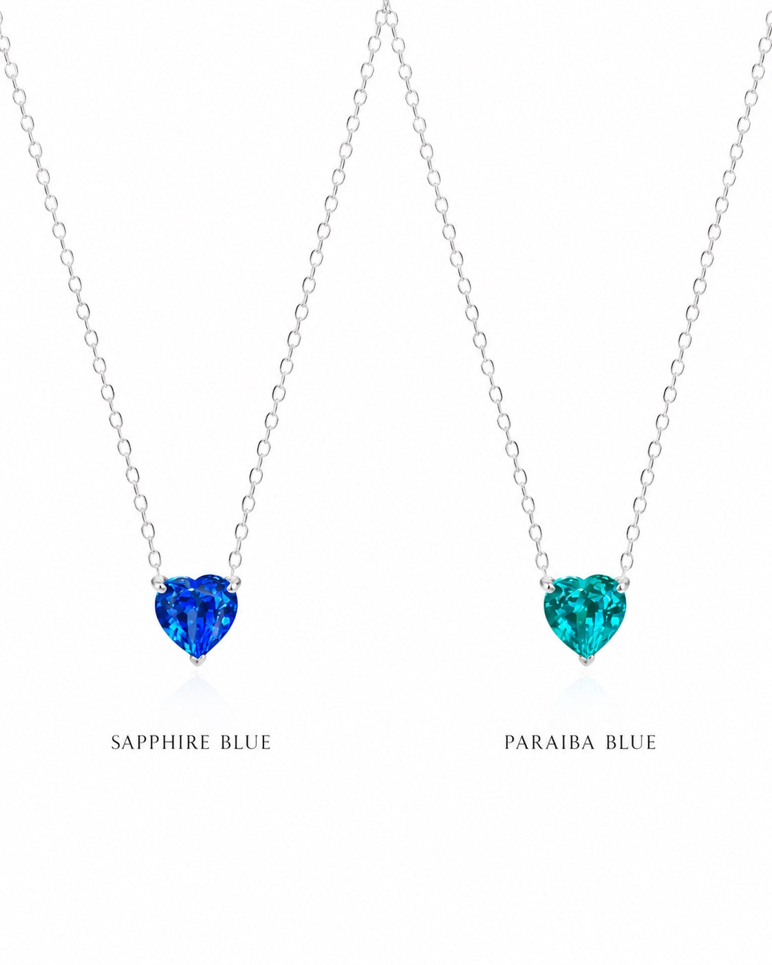 Two heart-shaped gemstone necklaces, one sapphire blue and one paraiba blue, on a white background.