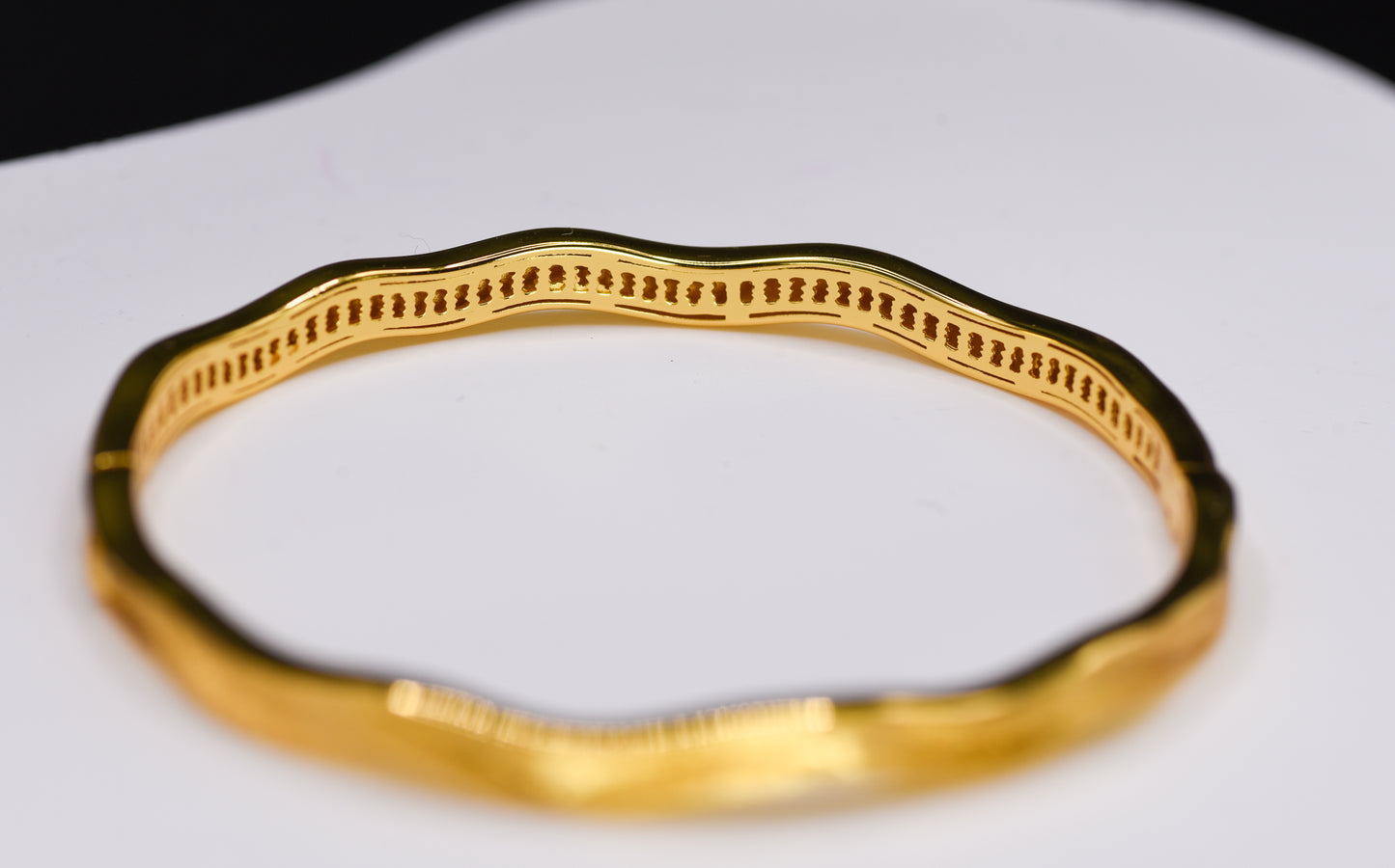 Gold color bracelet on a white background