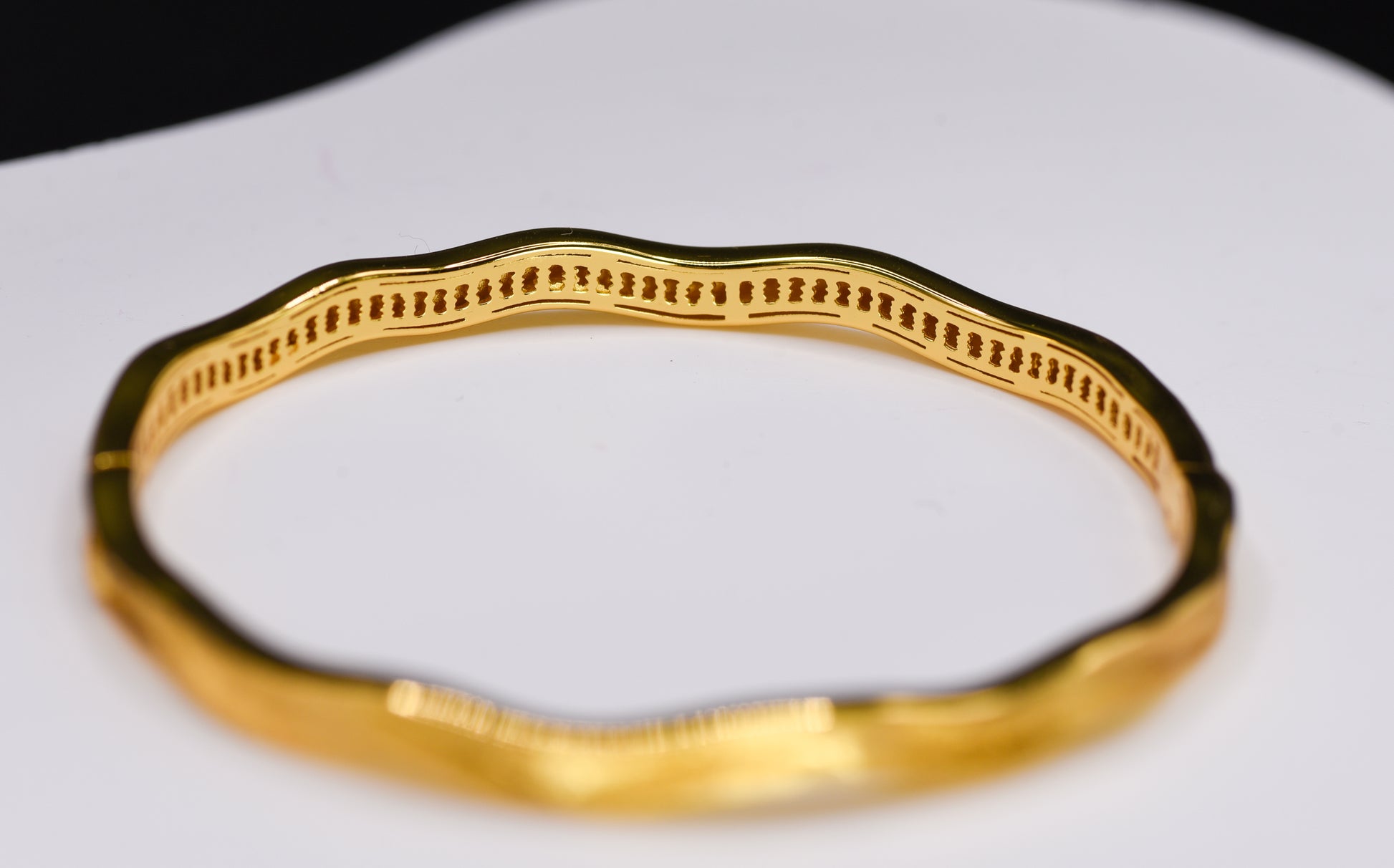 Gold color bracelet on a white background