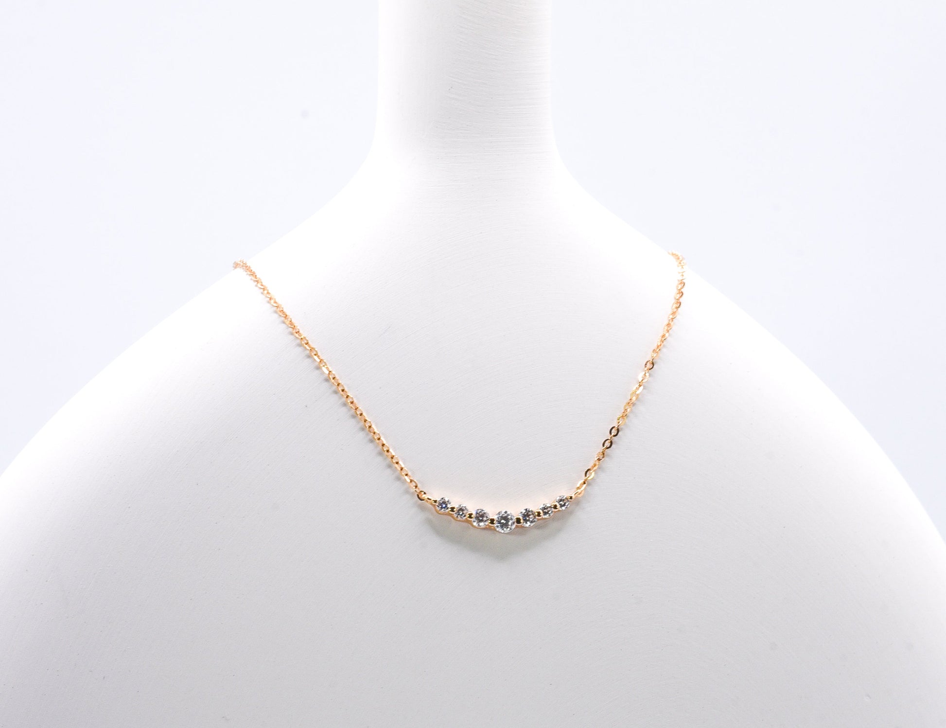 old color necklace with small gemstones on a light gray background