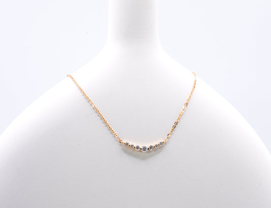 old color necklace with small gemstones on a light gray background