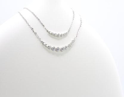 Silver necklaces with small Moissanite Stones  on a white background