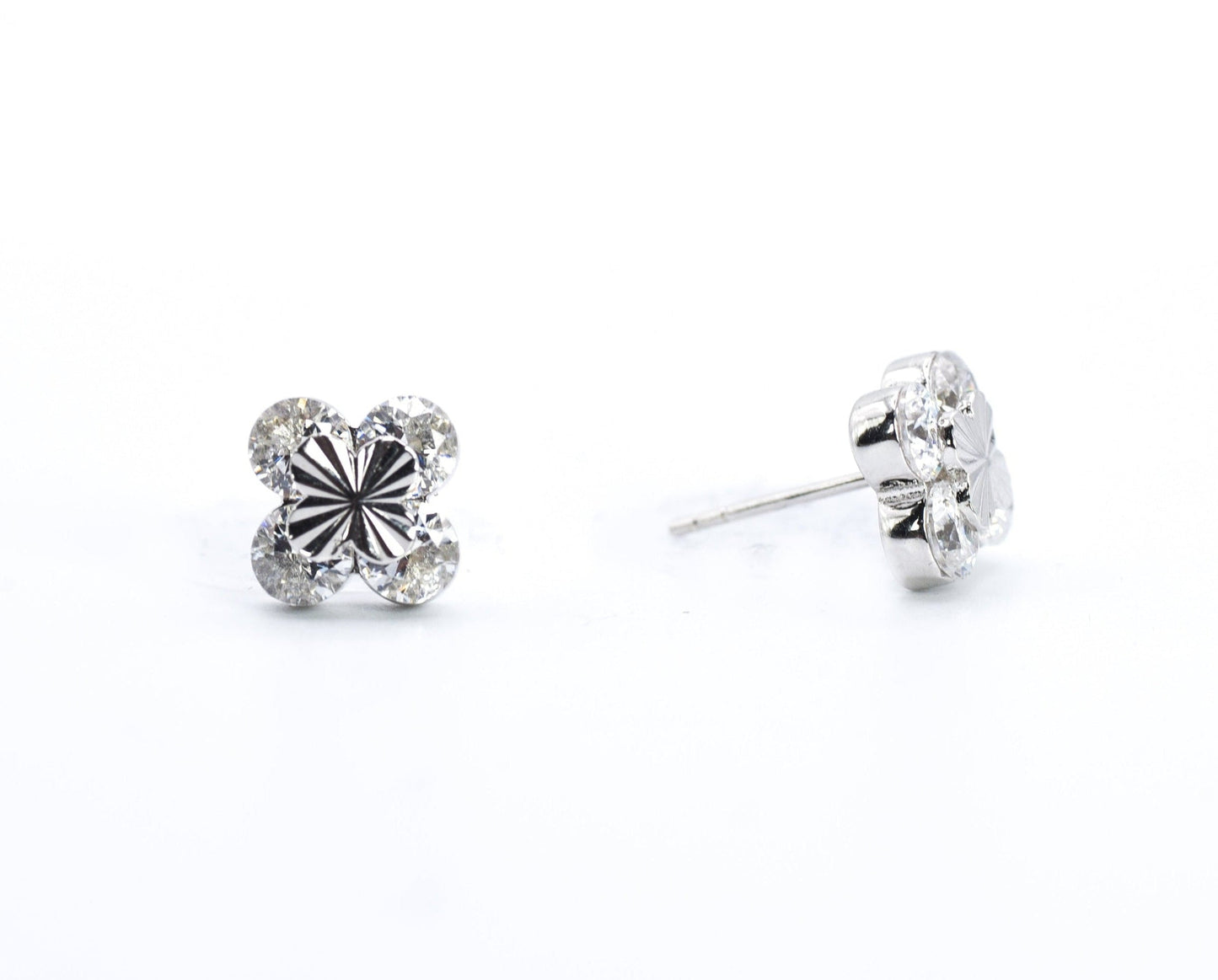 Pair of silver stud earrings on a white background