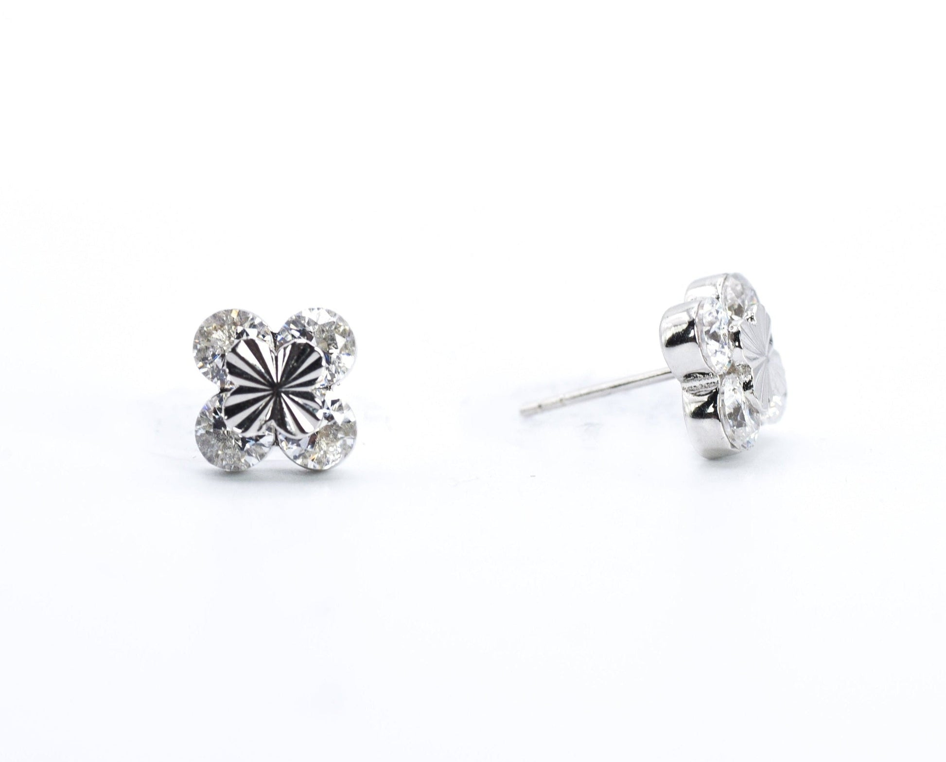 Pair of silver stud earrings on a white background