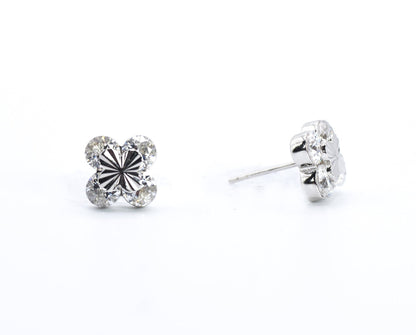 Pair of silver stud earrings on a white background